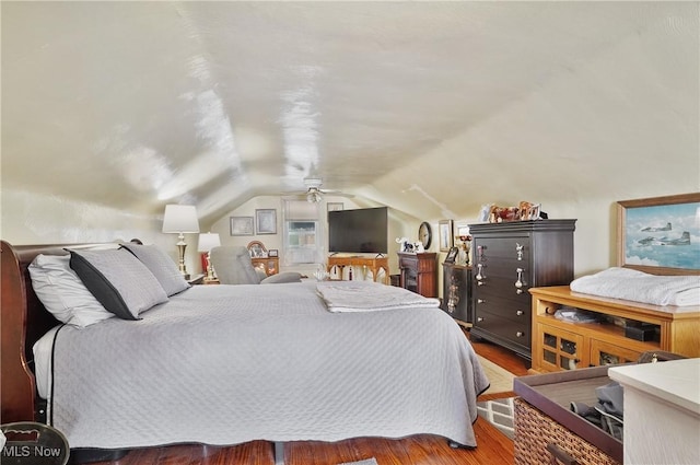 bedroom featuring hardwood / wood-style flooring, ceiling fan, and lofted ceiling