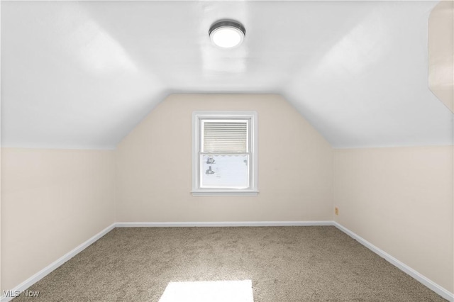 additional living space with lofted ceiling and carpet floors