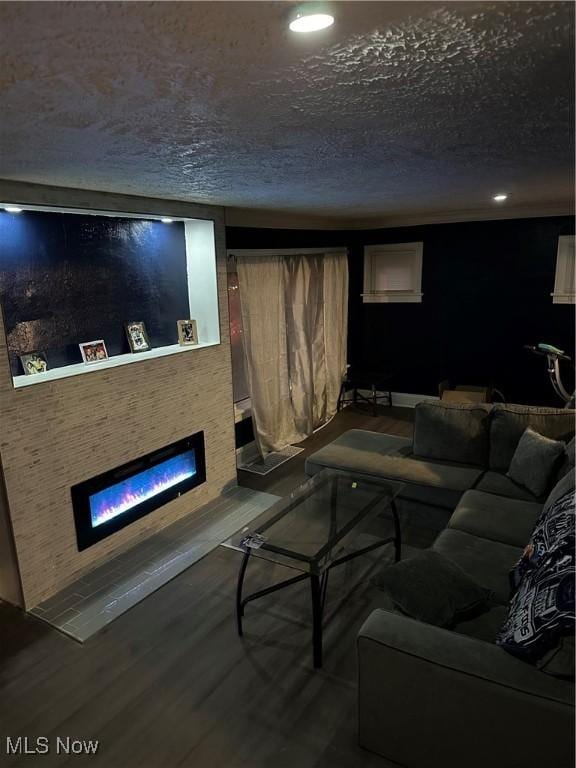 living room featuring wood-type flooring and a textured ceiling