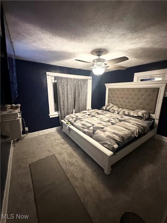 bedroom featuring a textured ceiling and ceiling fan