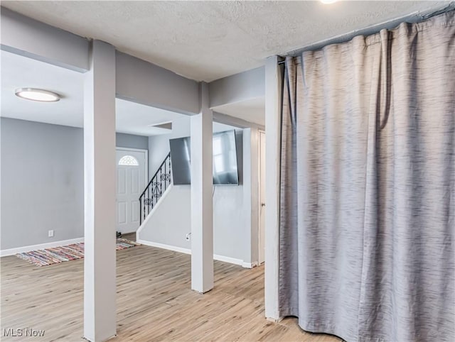 interior space with hardwood / wood-style flooring and a textured ceiling