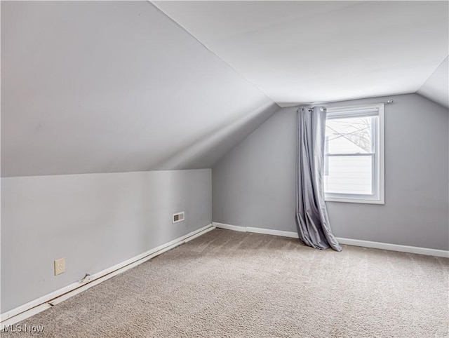 additional living space with lofted ceiling and carpet floors