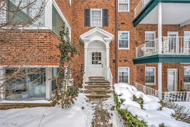 view of snow covered property entrance