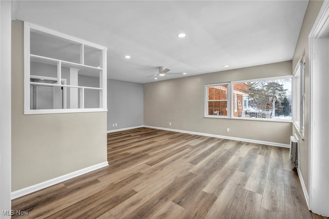 unfurnished room featuring ceiling fan and light wood-type flooring