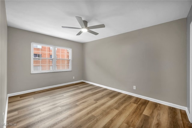 empty room with light hardwood / wood-style floors and ceiling fan