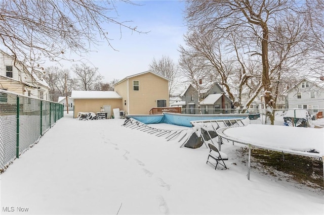 yard covered in snow with a covered pool