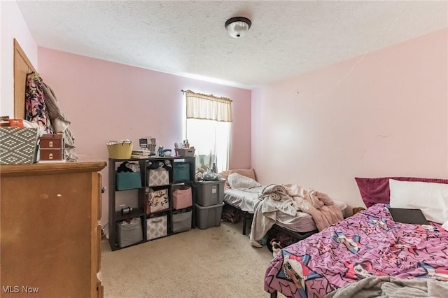 carpeted bedroom with a textured ceiling