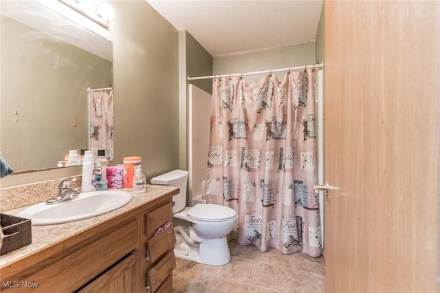 full bathroom featuring tile patterned floors, vanity, toilet, and shower / bath combo with shower curtain