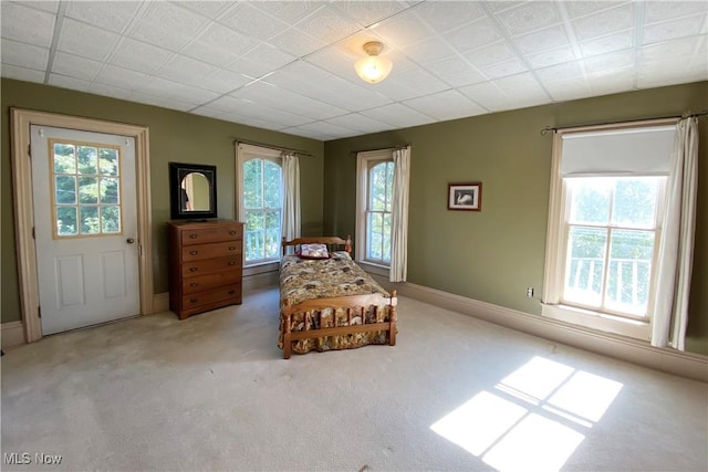 sitting room featuring a wealth of natural light and light carpet