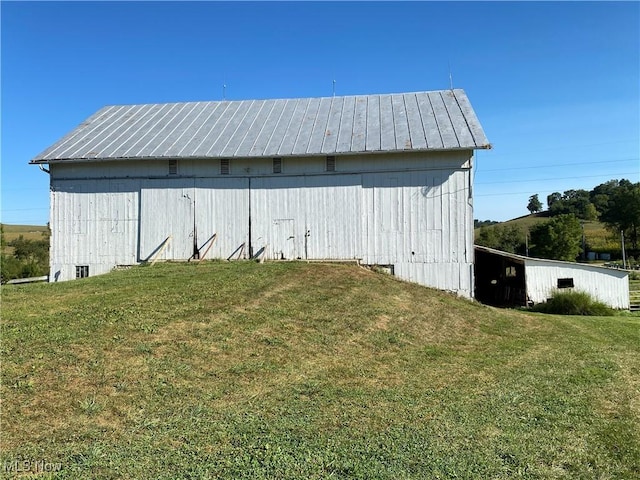 view of outbuilding featuring a lawn