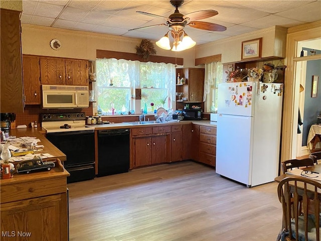 kitchen featuring ceiling fan, white appliances, and light hardwood / wood-style flooring