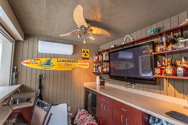 bar with sink, wooden walls, a wall unit AC, and ceiling fan