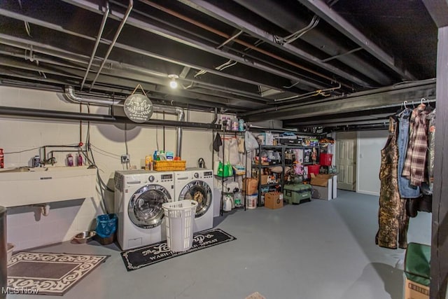 basement with sink and washer and dryer