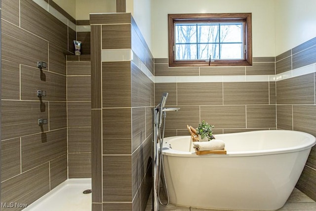 bathroom with independent shower and bath and tile walls