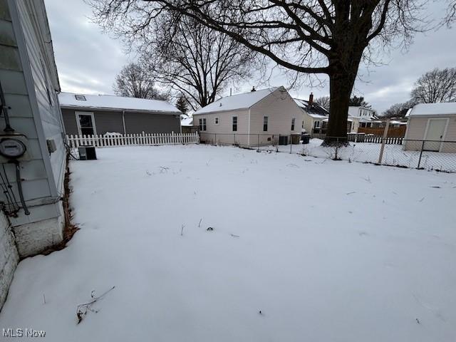 view of yard layered in snow