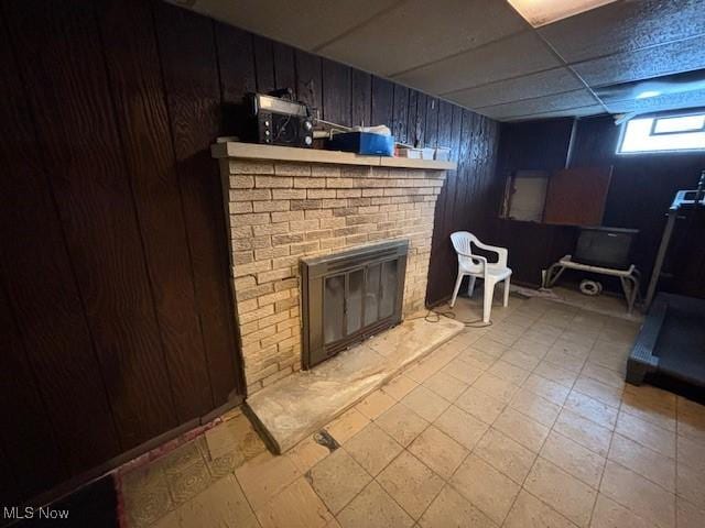 living room with a paneled ceiling and a fireplace