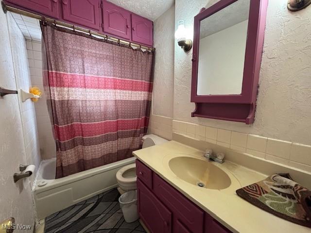 full bathroom with vanity, toilet, shower / bathtub combination with curtain, tile patterned floors, and a textured ceiling