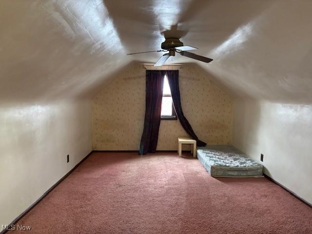 additional living space with lofted ceiling, carpet flooring, and ceiling fan