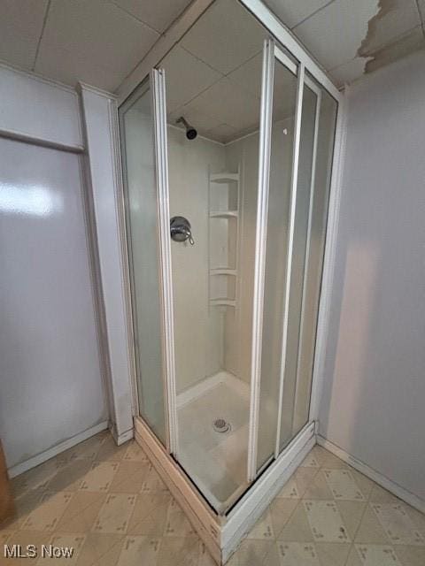 bathroom with a shower with door