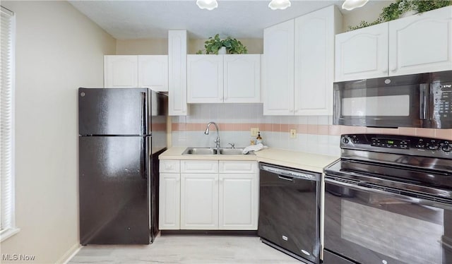 kitchen with tasteful backsplash, sink, white cabinets, and black appliances