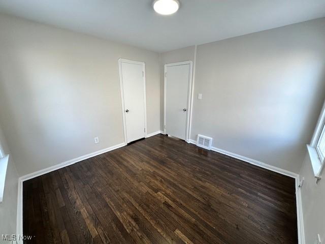 5111 Lucydale Ave, North Olmsted, OH 44070 - spare room featuring dark wood-type flooring and baseboards