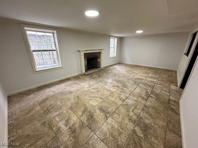 unfurnished living room with a brick fireplace