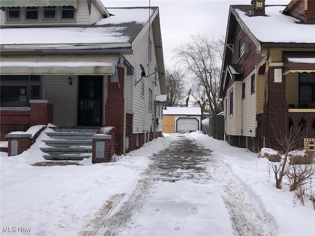 view of snow covered exterior featuring a garage