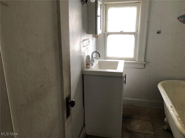 bathroom with vanity and a bathtub