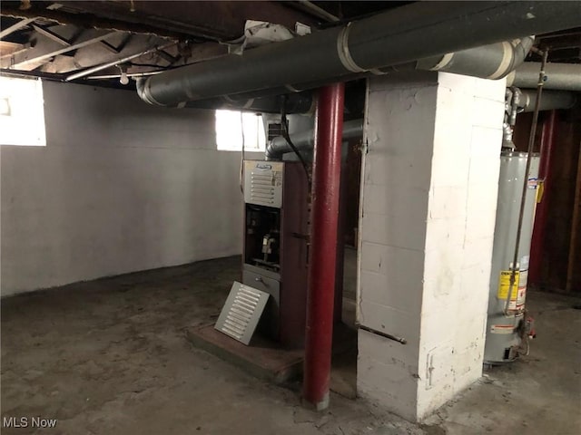 basement featuring a healthy amount of sunlight and gas water heater