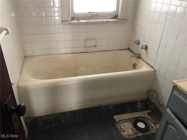 bathroom featuring tile walls and vanity