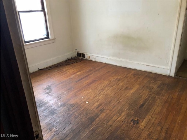 unfurnished room featuring hardwood / wood-style flooring