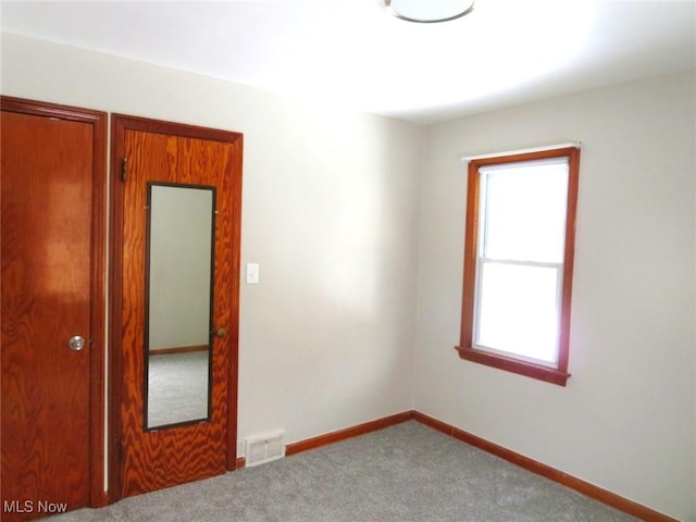 unfurnished room featuring carpet flooring