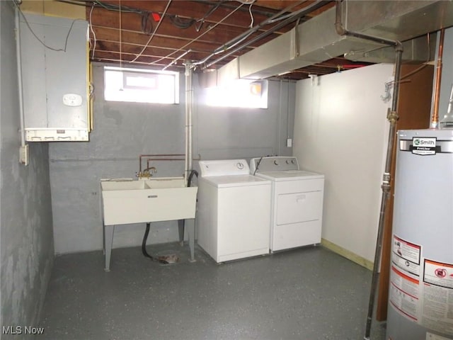 laundry area featuring sink, washer and dryer, and gas water heater