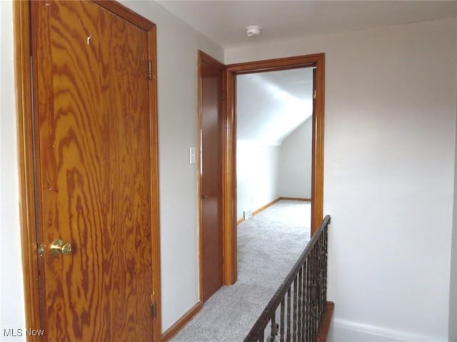 hall featuring light carpet and lofted ceiling