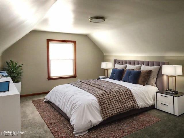 bedroom with lofted ceiling and dark carpet