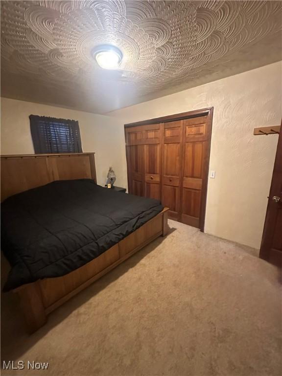 unfurnished bedroom featuring carpet floors and a closet