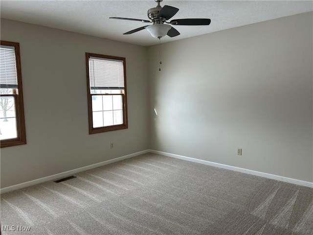 unfurnished room featuring ceiling fan and carpet flooring