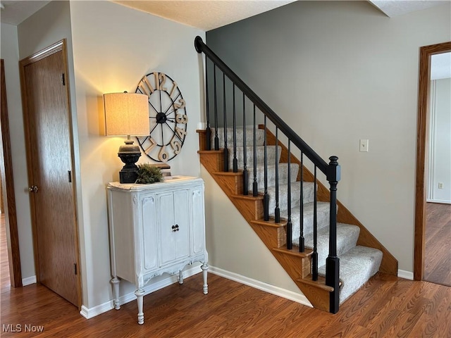 stairway featuring wood-type flooring