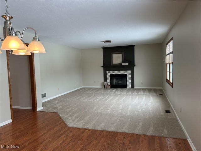 unfurnished living room with a fireplace and dark hardwood / wood-style flooring