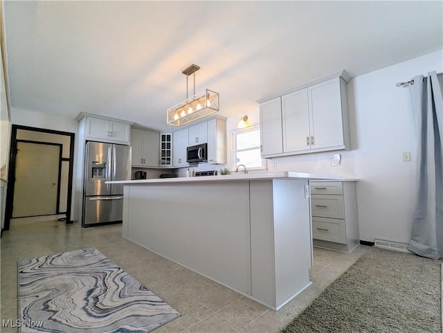 kitchen with sink, white cabinetry, decorative light fixtures, a center island, and appliances with stainless steel finishes