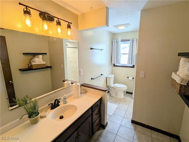 bathroom featuring vanity, toilet, tile patterned flooring, and a textured ceiling