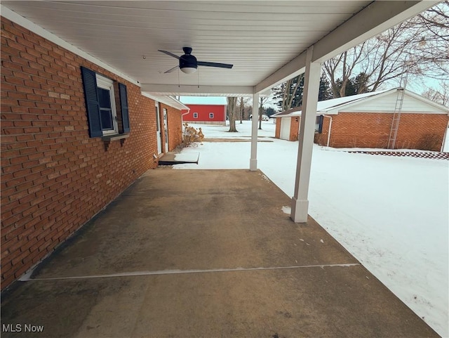 snow covered patio featuring ceiling fan