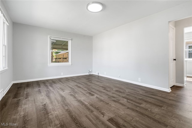 empty room with dark hardwood / wood-style floors