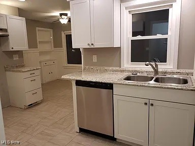 kitchen featuring white cabinetry, stainless steel dishwasher, ceiling fan, and sink