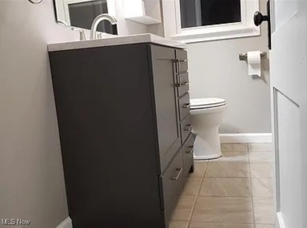 bathroom with vanity, toilet, and tile patterned flooring