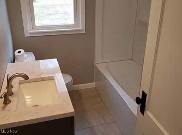 bathroom with tile patterned floors, vanity, and toilet