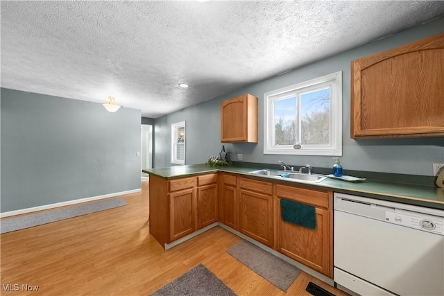 kitchen with sink, a textured ceiling, white dishwasher, kitchen peninsula, and light hardwood / wood-style floors