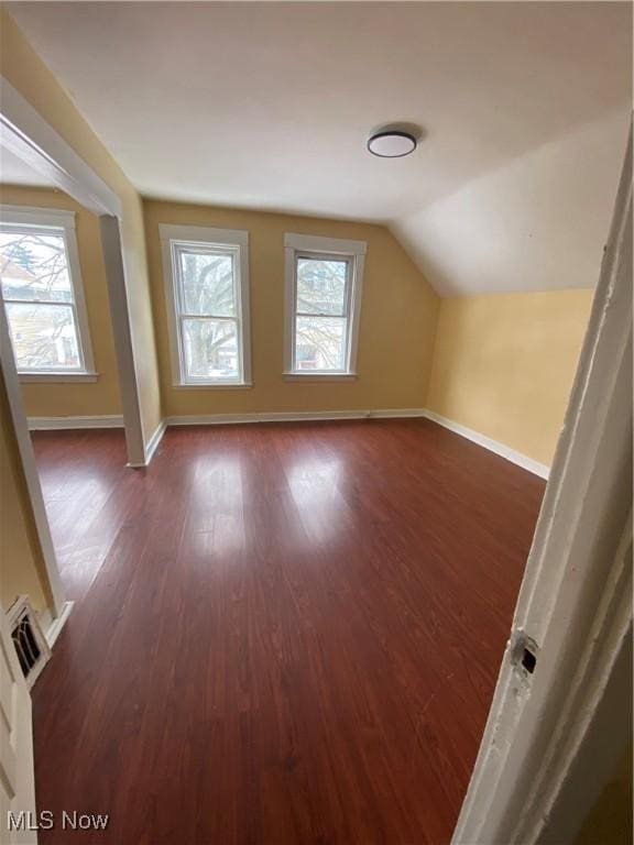 bonus room featuring vaulted ceiling and dark hardwood / wood-style floors