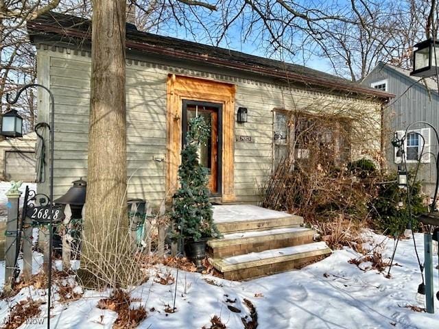 view of snow covered property entrance