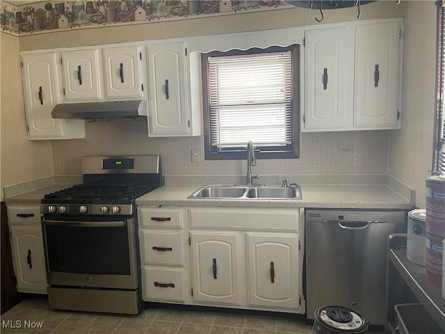 kitchen featuring tile patterned flooring, sink, stainless steel appliances, and white cabinets